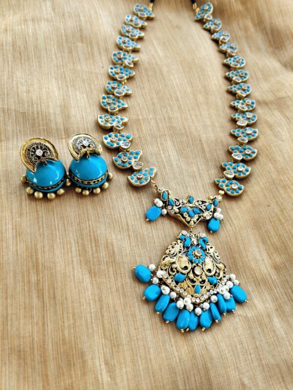 ARPITHA- Terracotta Long Necklace with medium size jhumka ( Golden with Sky Blue )